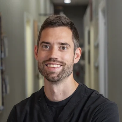 A headshot of Dr. Tyler Leopardi, a chiropractor at Avenue One Health Center.